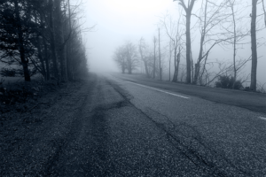 creepy foggy road in black & white