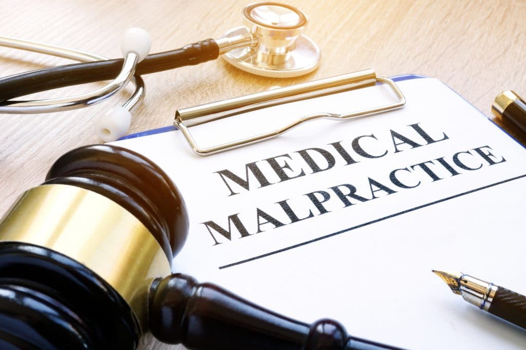 Clipboard With Documents About Medical Malpractice And Gavel.