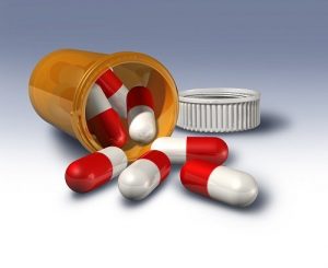 Pills spilling from prescription bottle