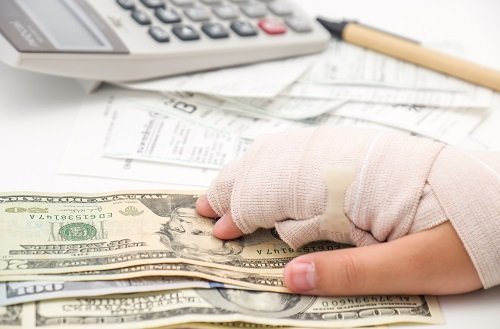 money-injured-hand-and-calculator