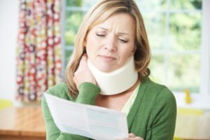 woman with neck injury wearing neck brace