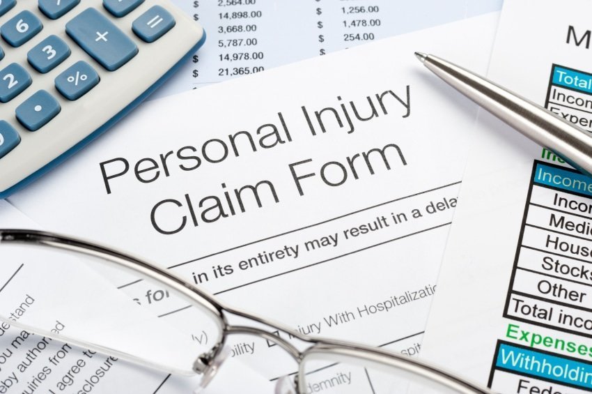 Personal Injury Claim Form With Pen, Calculator