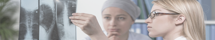 Doctor reviewing x-ray with cancer patient