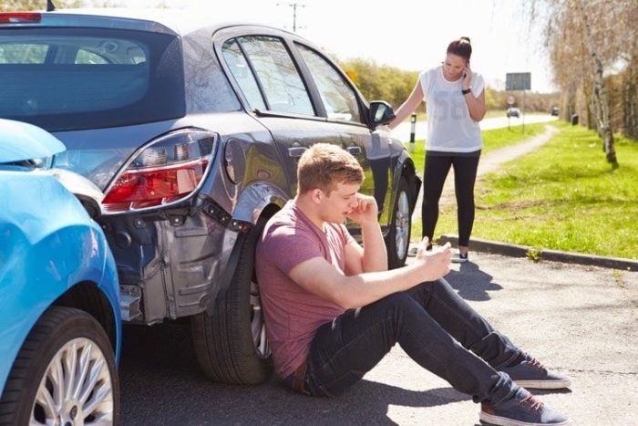 Man and woman making calls after a PA car accident